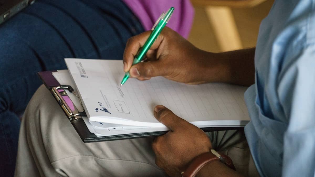 a person taking notes without a transcription machine