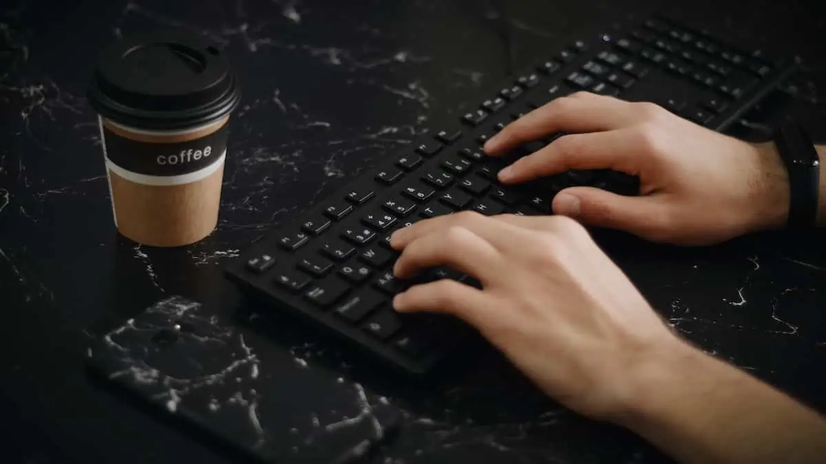 a person with a keyboard and a coffee