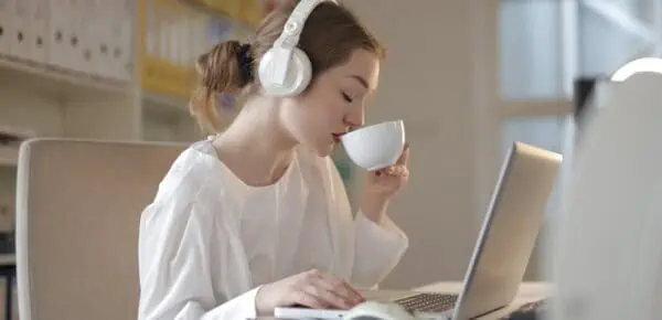 Woman in White Dress Shirt Using White Laptop Computer