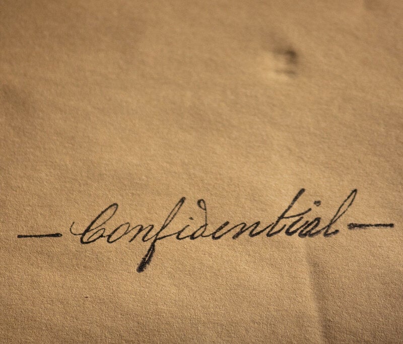 a document with the word confidential on it.