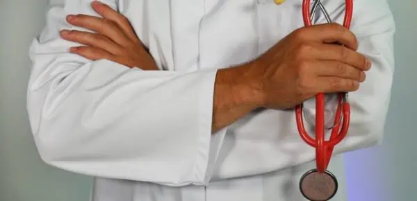 doctor holding red stethoscope - feature image for how to choose a medical transcription service provider