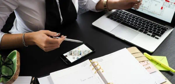 a real estate agent Pointing on the Screen of a Laptop who will then use transcription services to convert what was said to written text