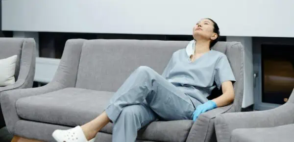 Photo Of Tired Doctor Resting On The Couch