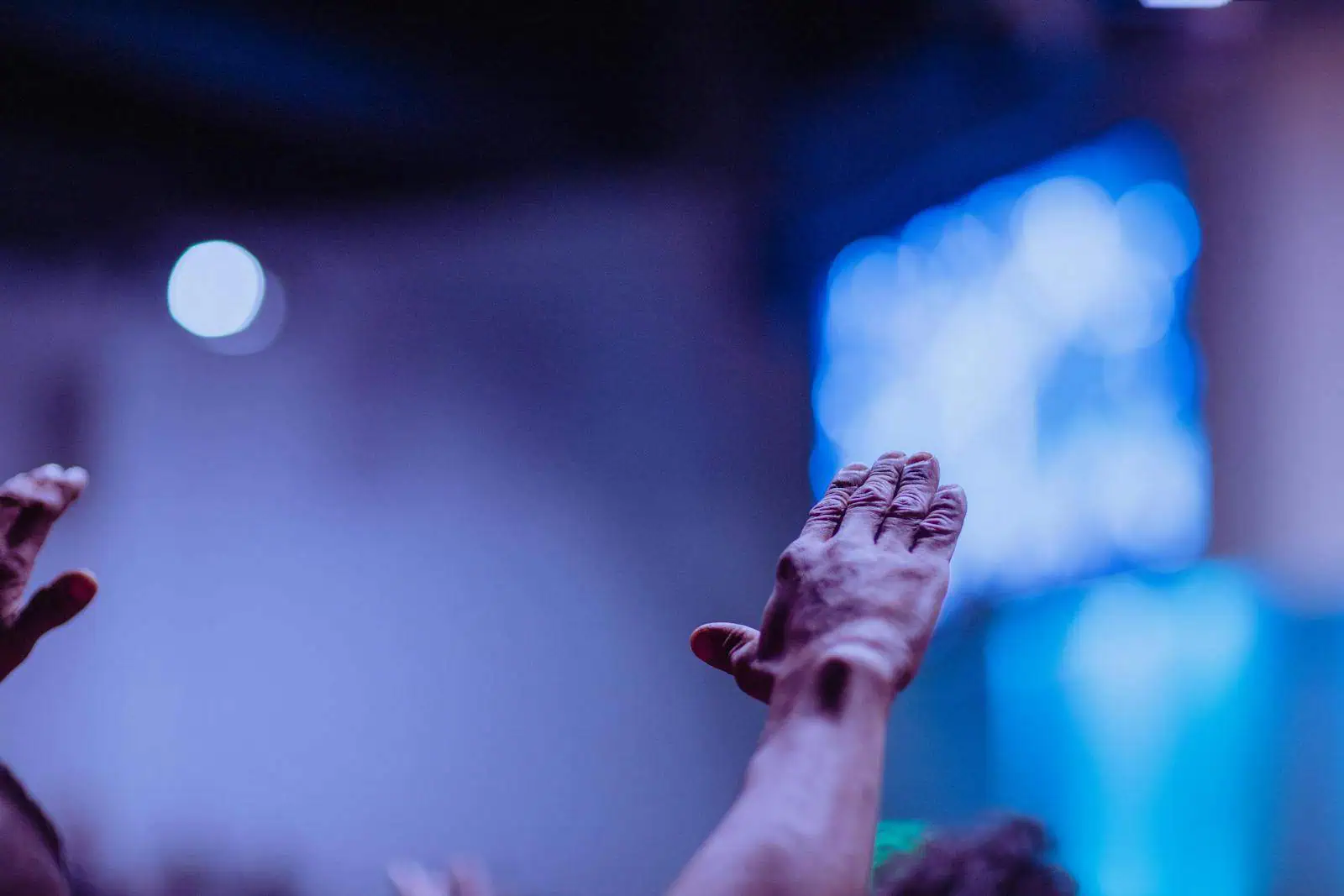 Person Raising Hand during sermon